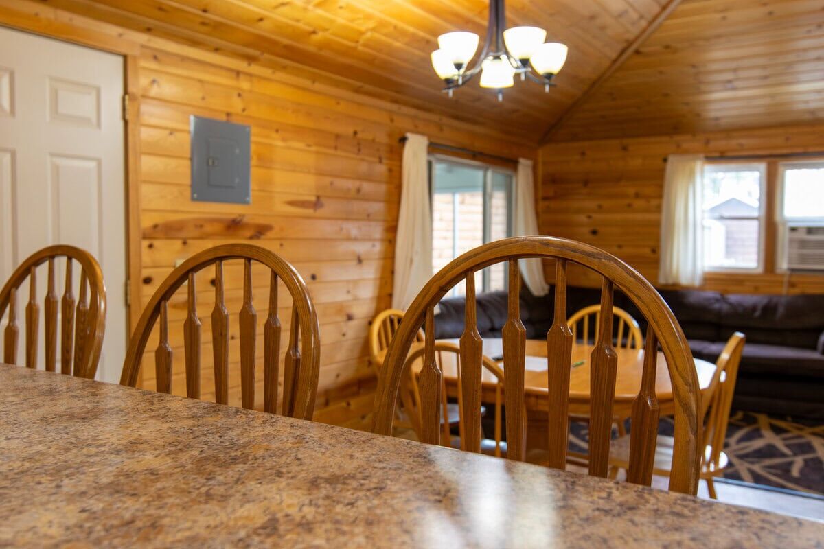Big River Escape Cabins-18 Cozy wooden interior of a cabin in Buffalo County Wisconsin, featuring a dining area and rustic décor.